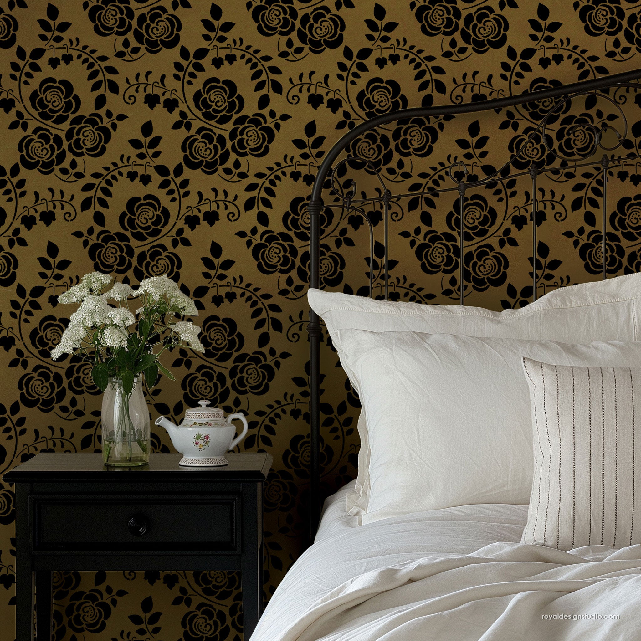 Dramatic Art Nouveau stencil pattern stenciled in gold and black with iron bed
