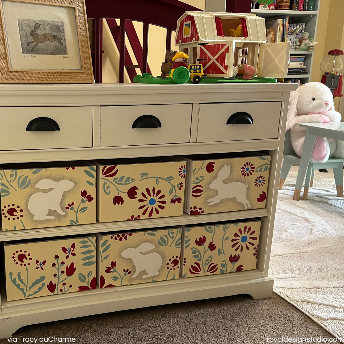 Stenciled storage chest in child's room with flower and bunny motif stencil
