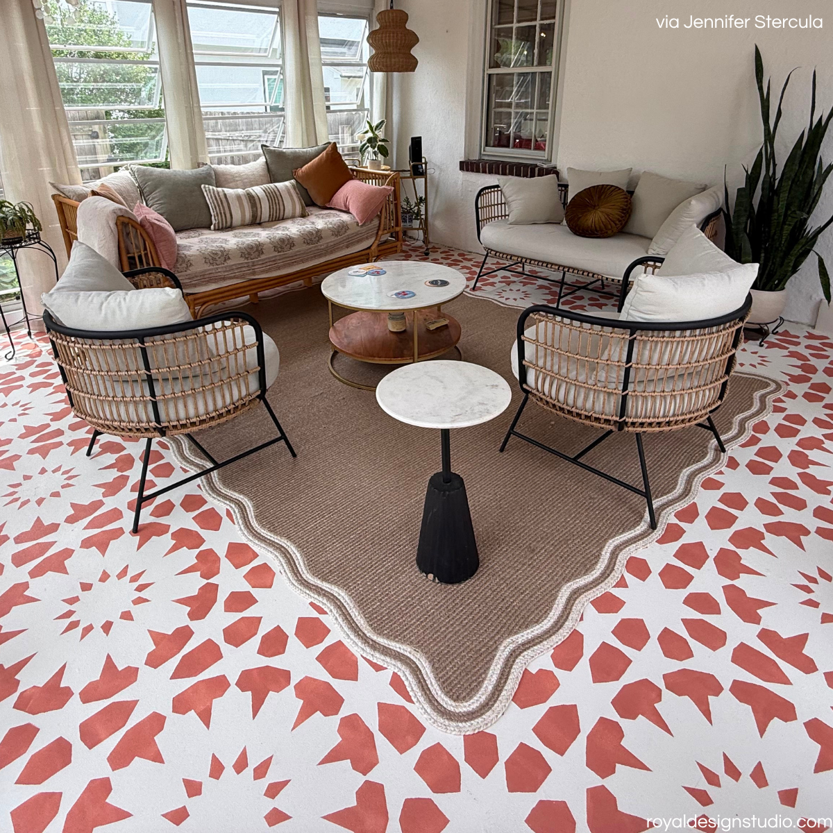 Concrete enclosed patio stenciled with a large scale Moroccan pattern and decorated with a bohemian style