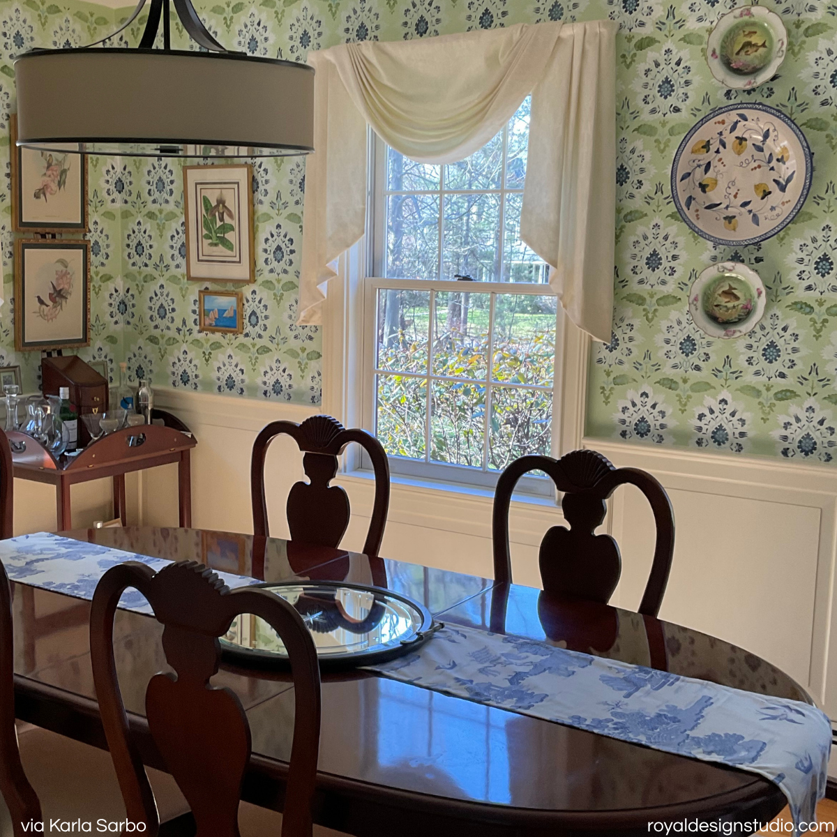 Suzani wall stencil pattern painted to look like wallpaper in a formal dining room