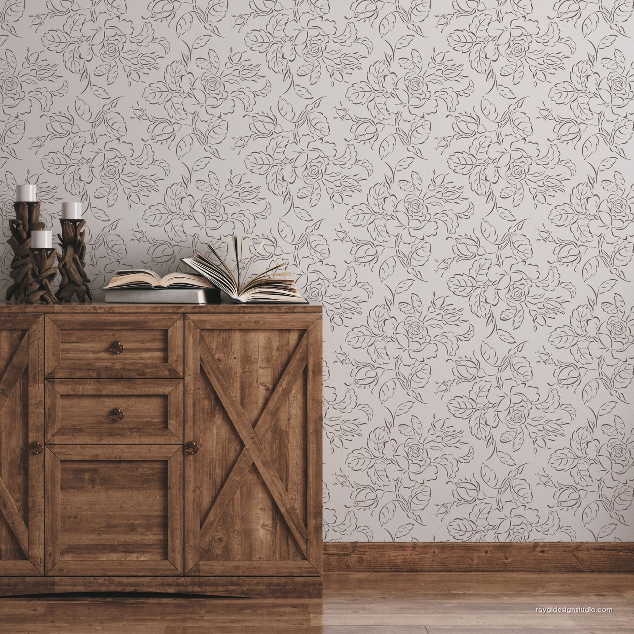 Country cottage cabbage rose wall stencil painted on a entry wall with brown rustic chest and accessories