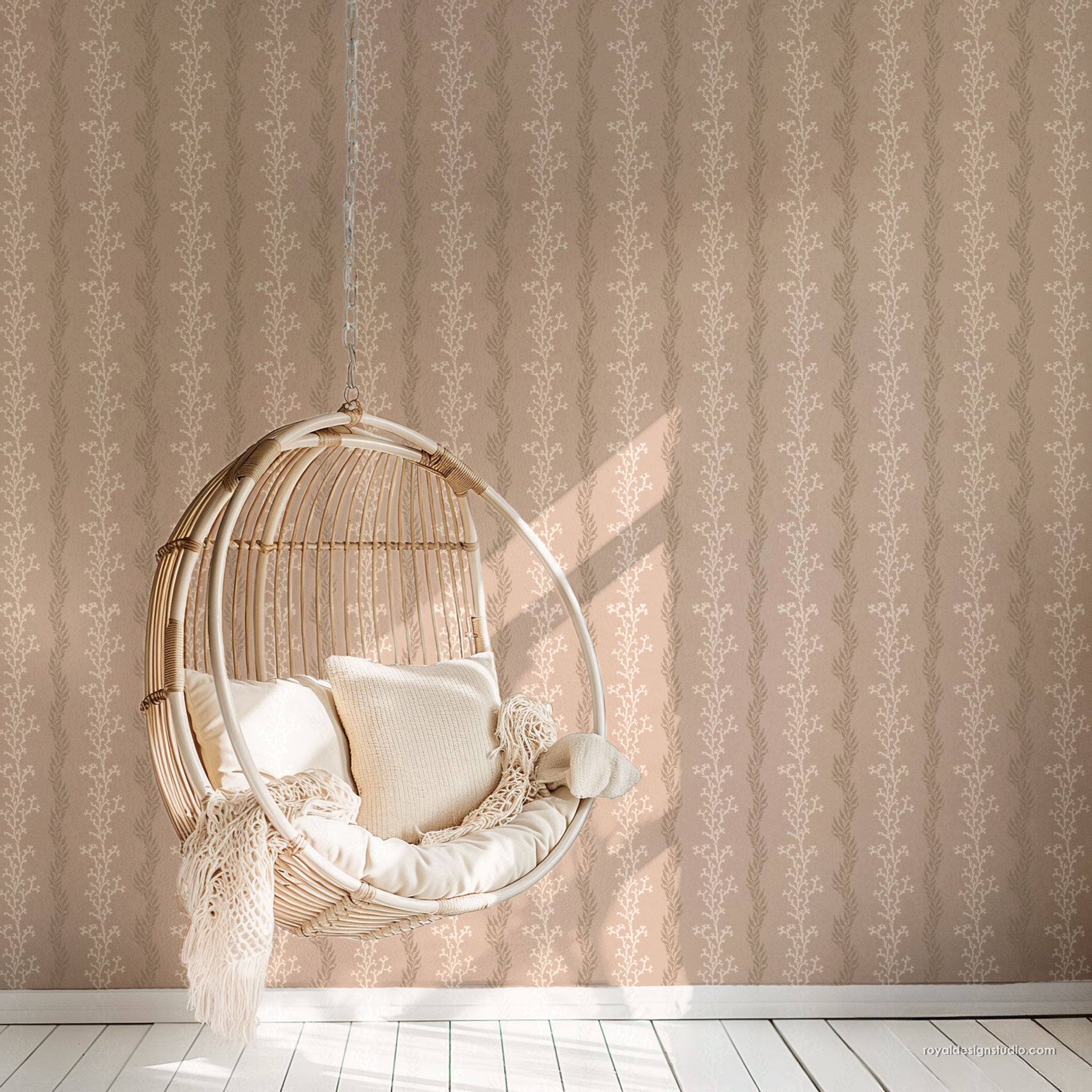 Coral coastal wall stencil stripe design on a wall with Woven chair with cushions
