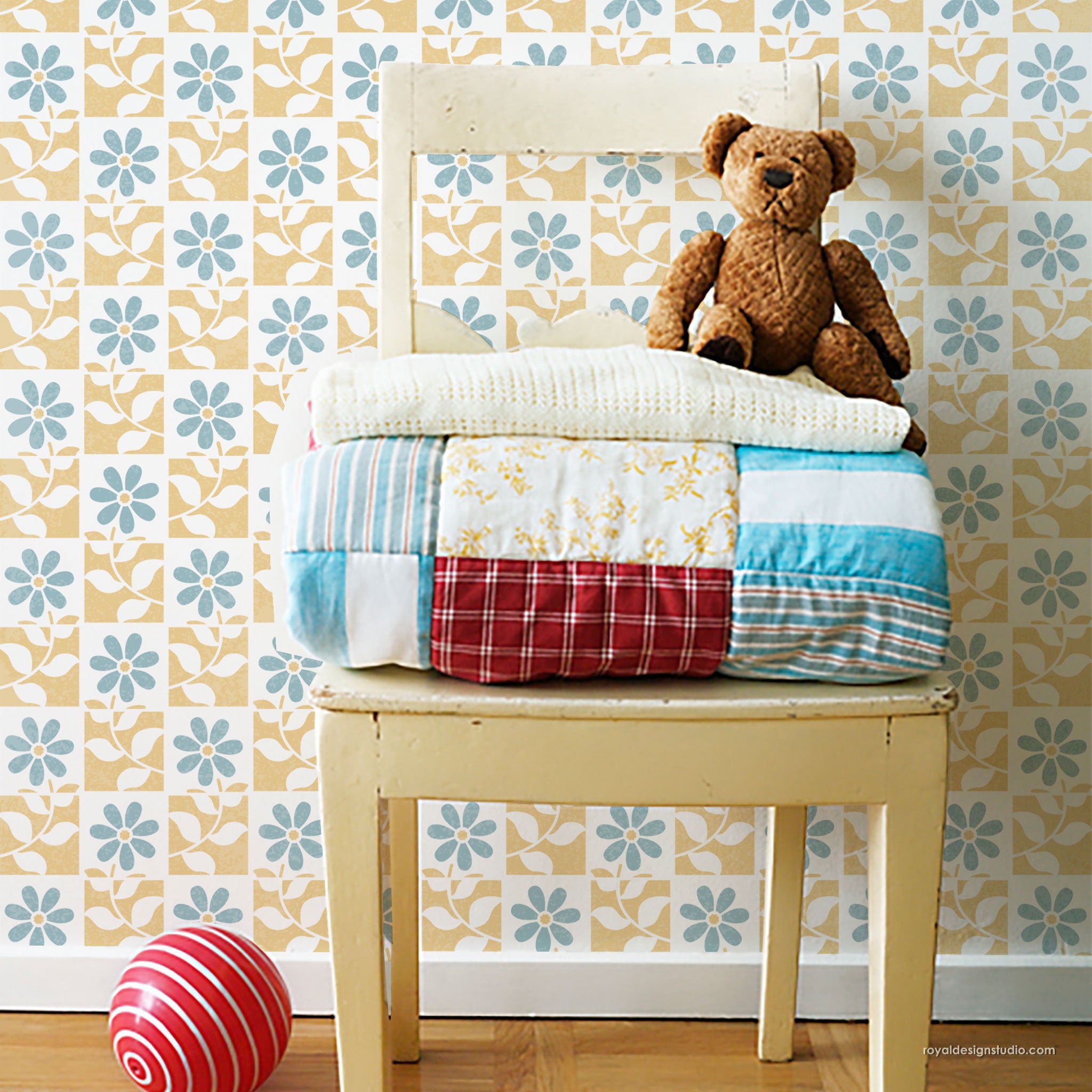 Cute painted wall with floral tile stencil pattern in blue and yellow in a nursery