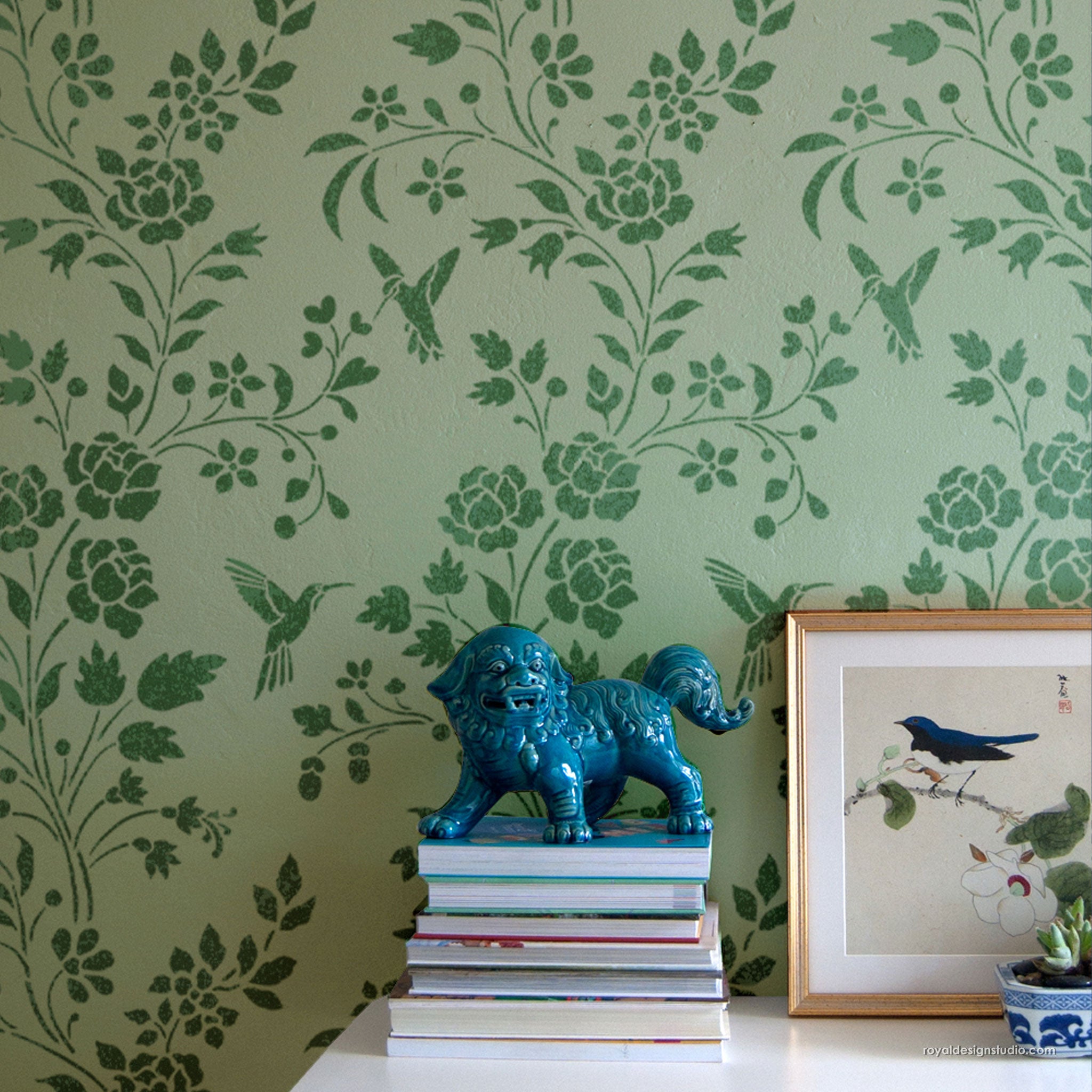 Decorative blue lion figure on books with floral wall stencil pattern in the background