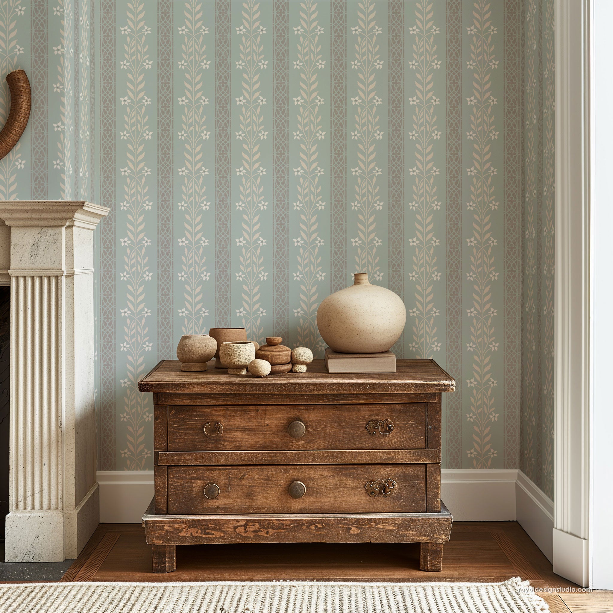 Floral stripe wall stencil pattern stenciled to look like wallpaper on a blue wall with rustic wooden chest
