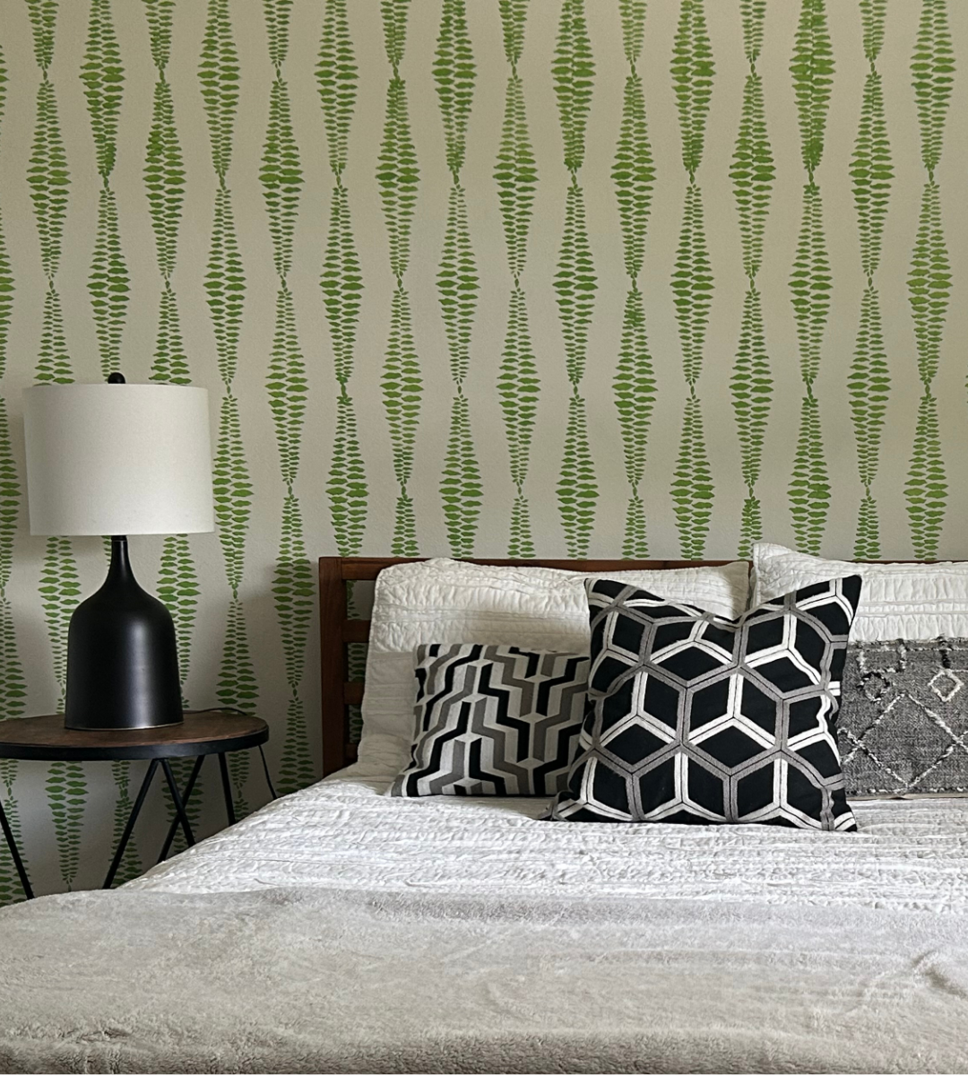 Modern style wall stencil with green paint on a bedroom wall