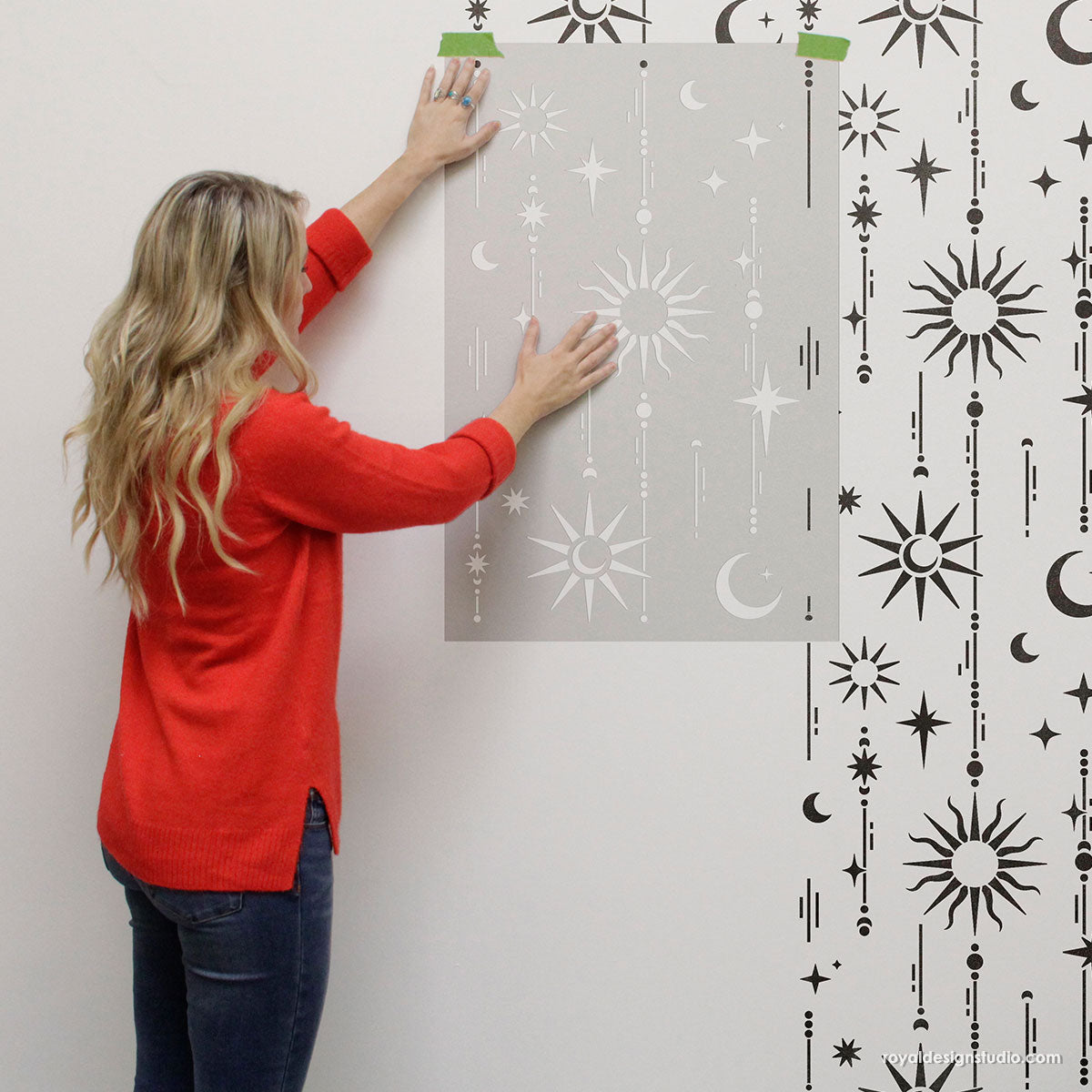 Stenciling walls with large star and moon celestial stencil
