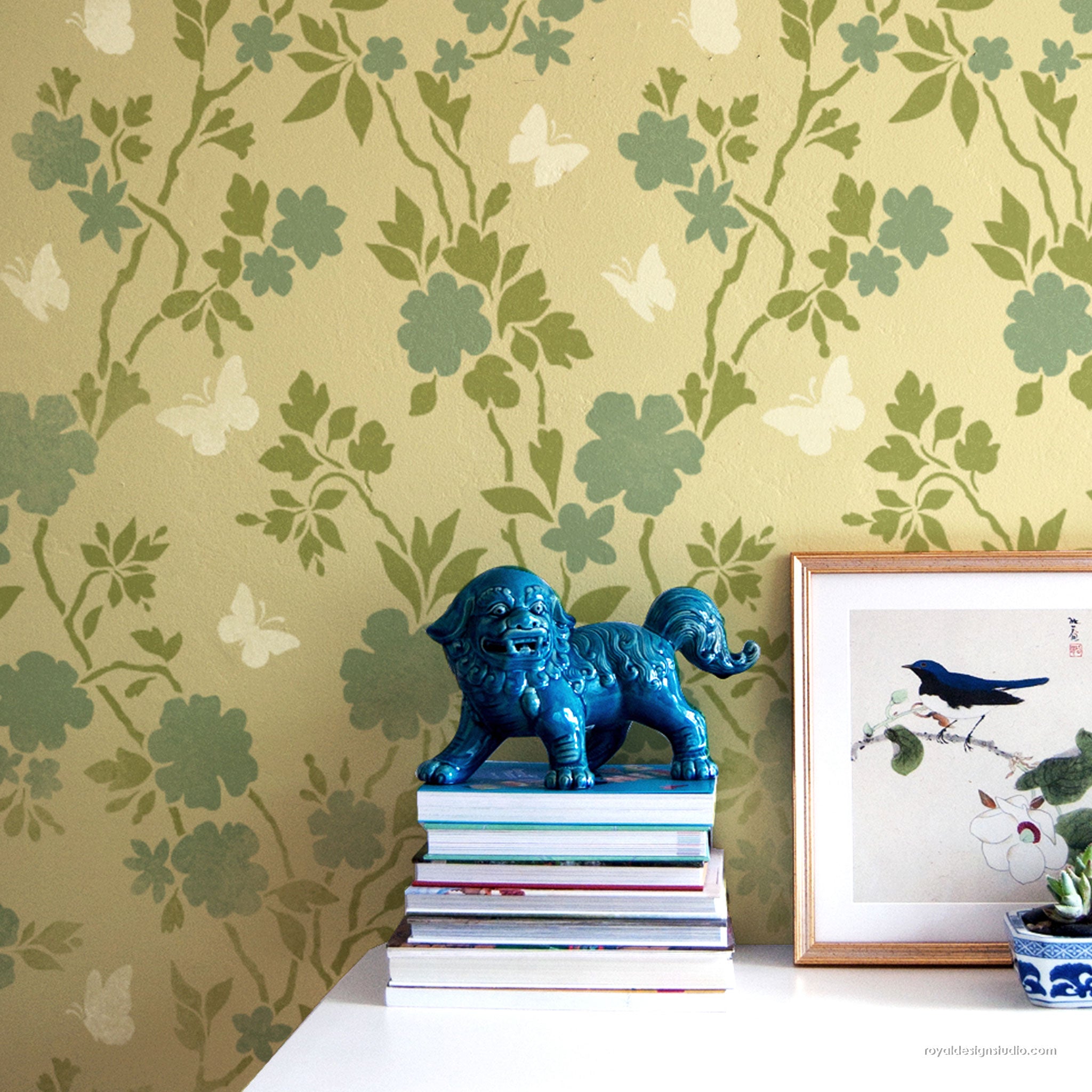 Butterfly and floral chinoiserie wallpaper pattern stenciled on a bedroom wall