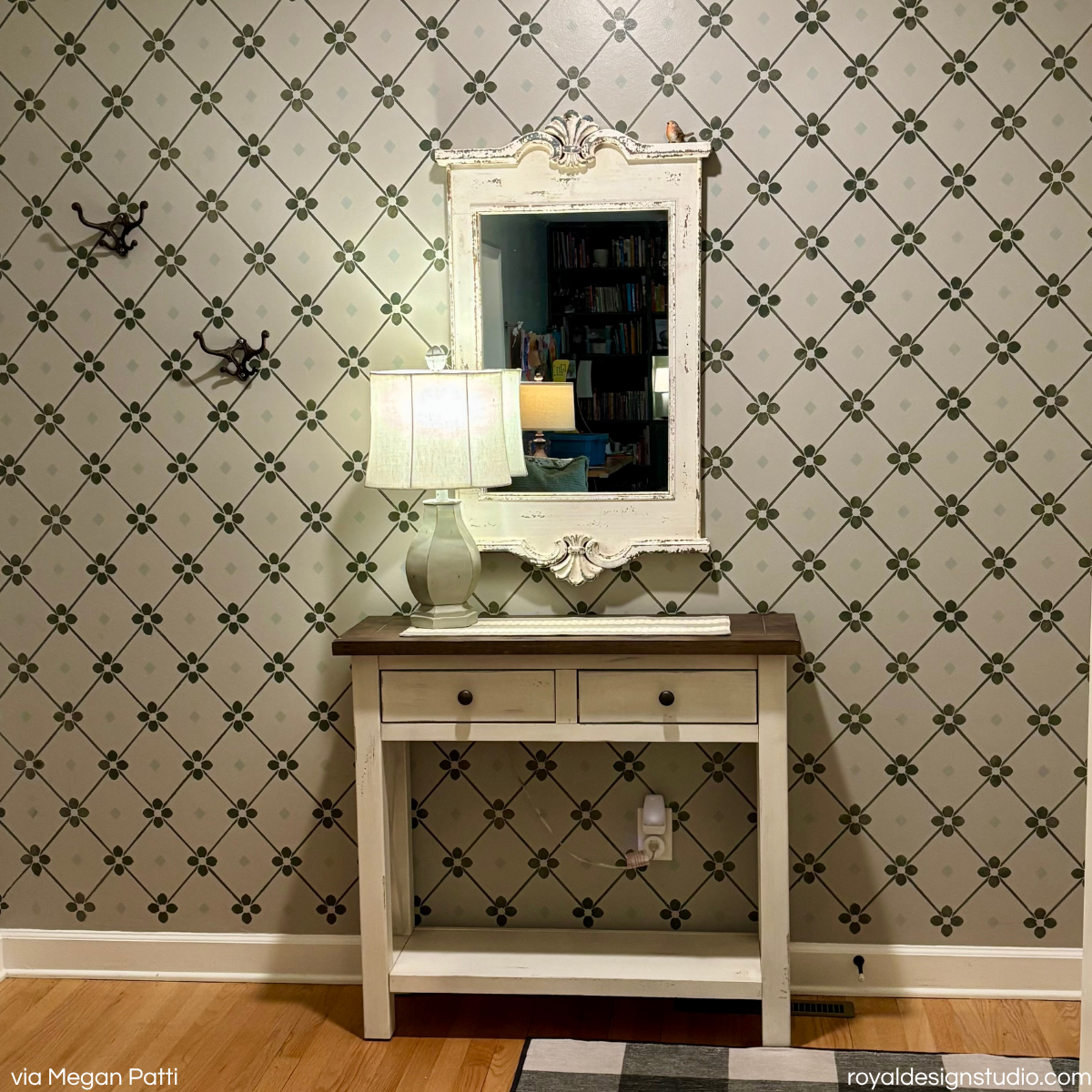 Diamond trellis wall stencil pattern stenciled in a hallway with a console and mirror