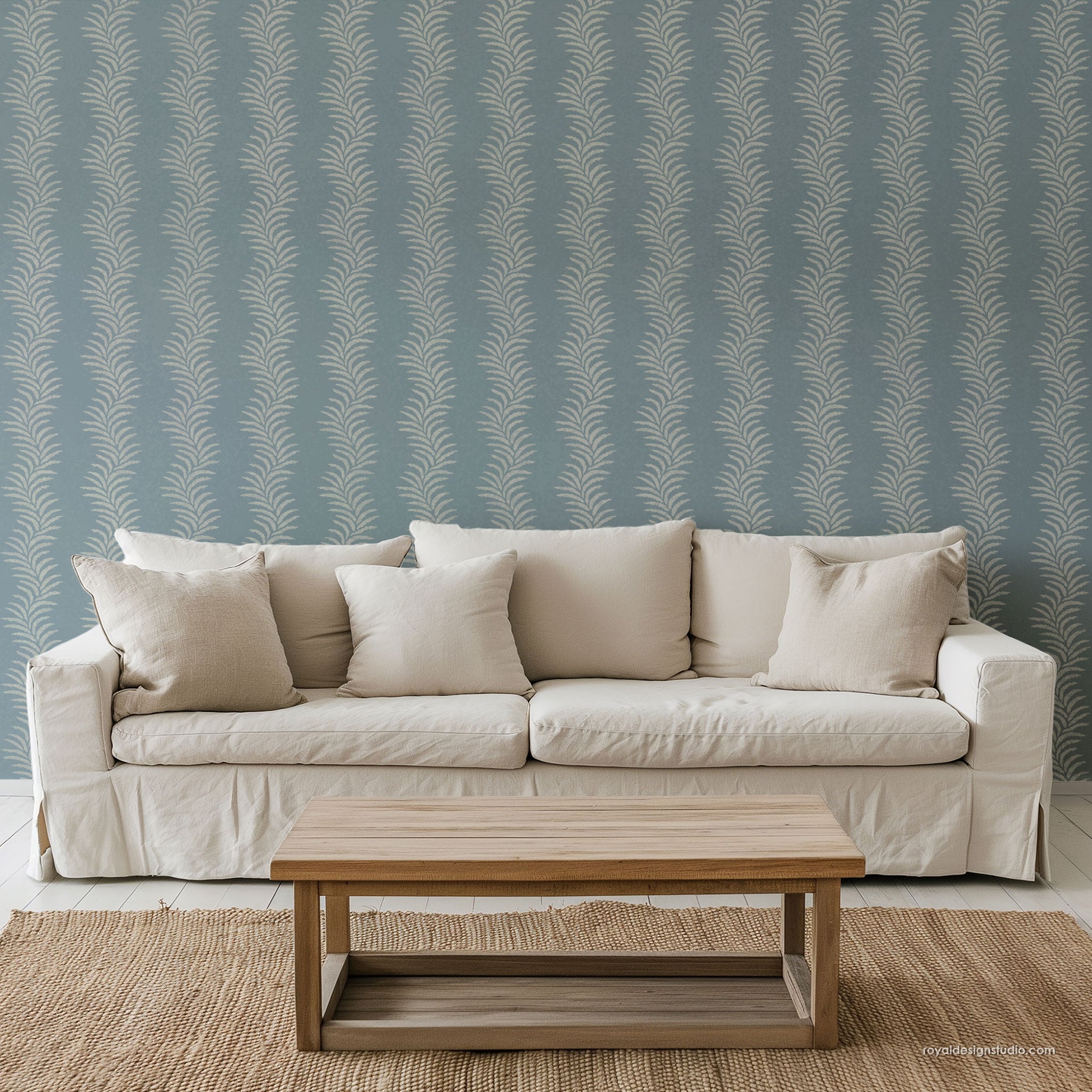 coastal cottage style living room with pretty fern stripe wall stencil pattern painted behind white couch