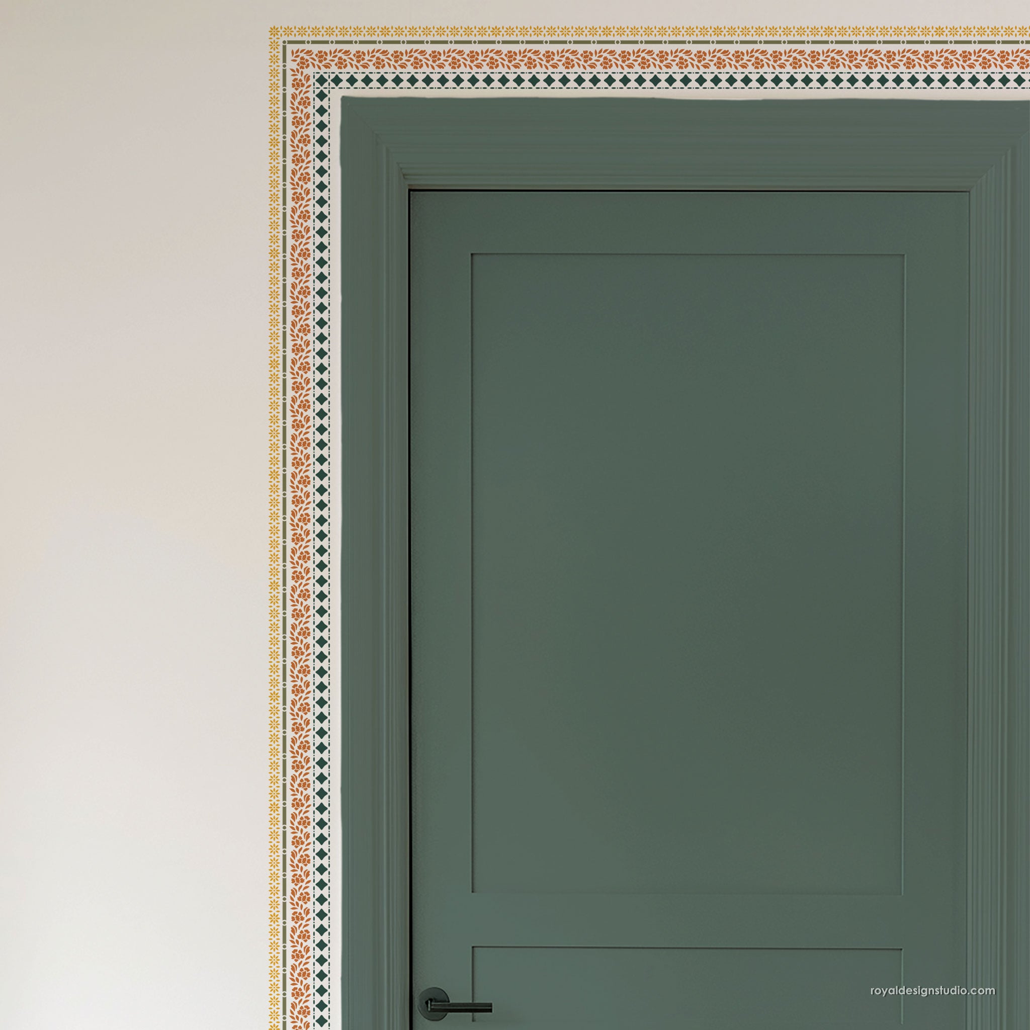 A close-up of a painted interior door in muted sage green, shown with a decorative border pattern along the top and left edges against an off-white wall.