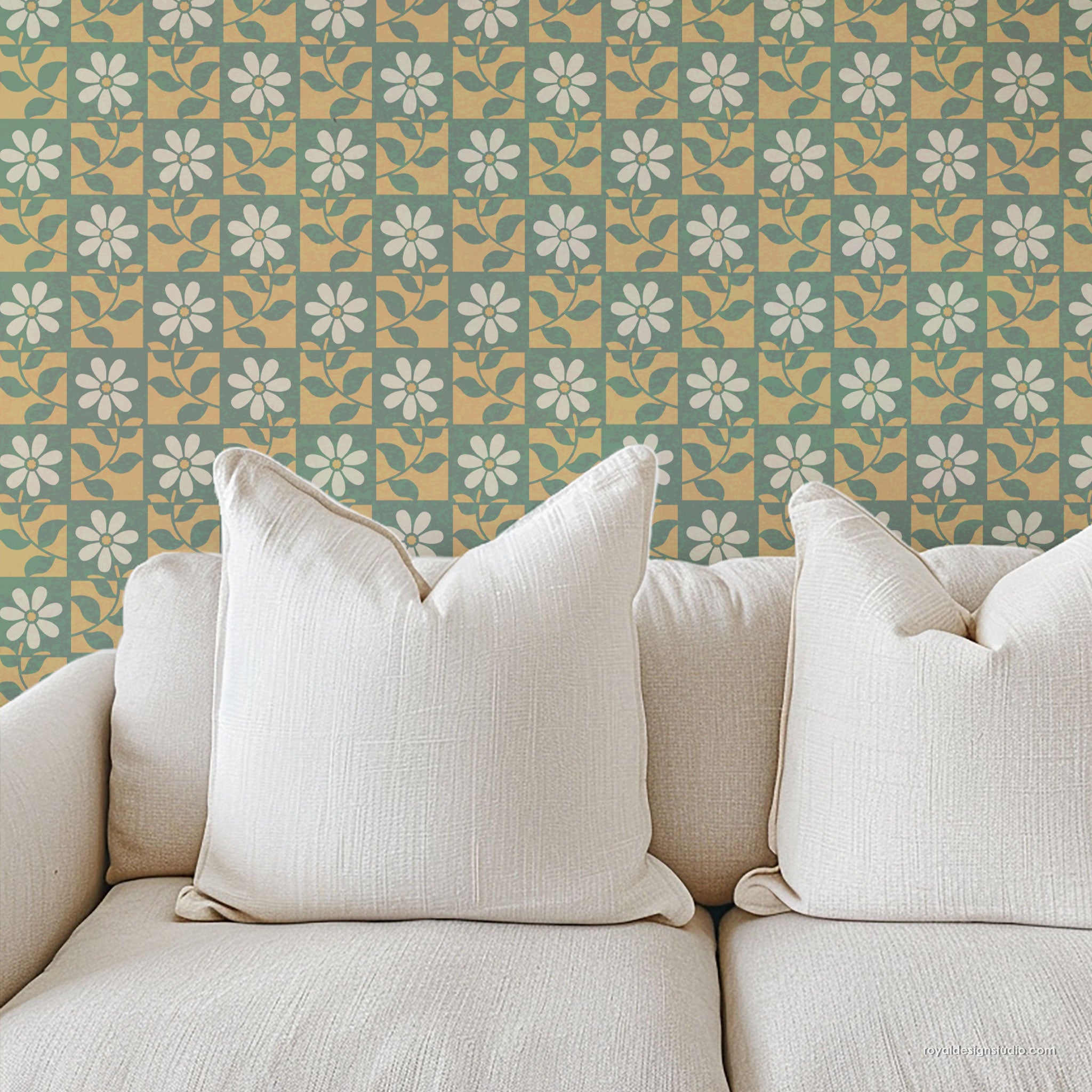 Beige sofa with decorative pillows against a floral patterned wall painted with a large stencil design