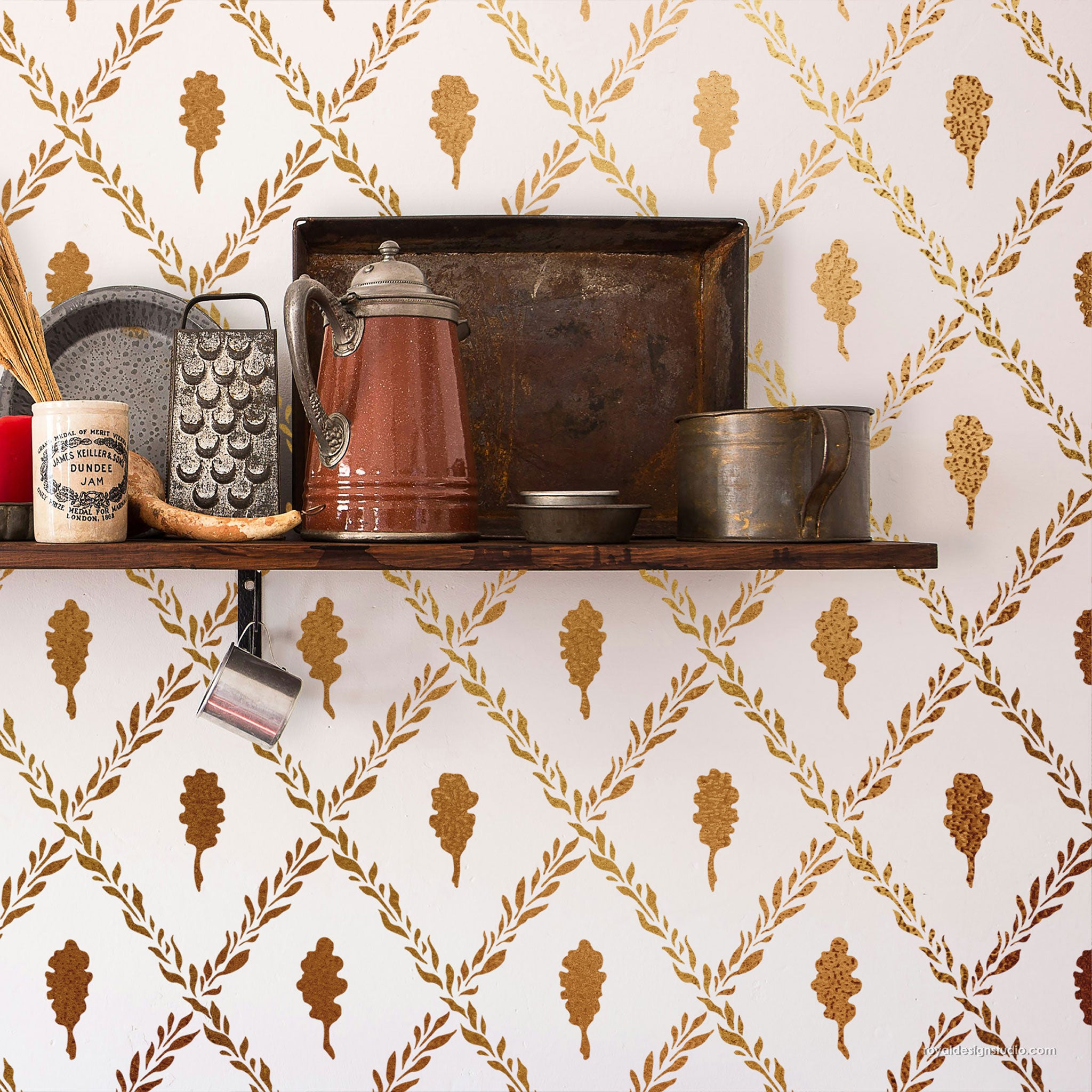 Decorative shelf with kitchen items against a wall with a leaf pattern stencil stenciled in metallic gold paint
