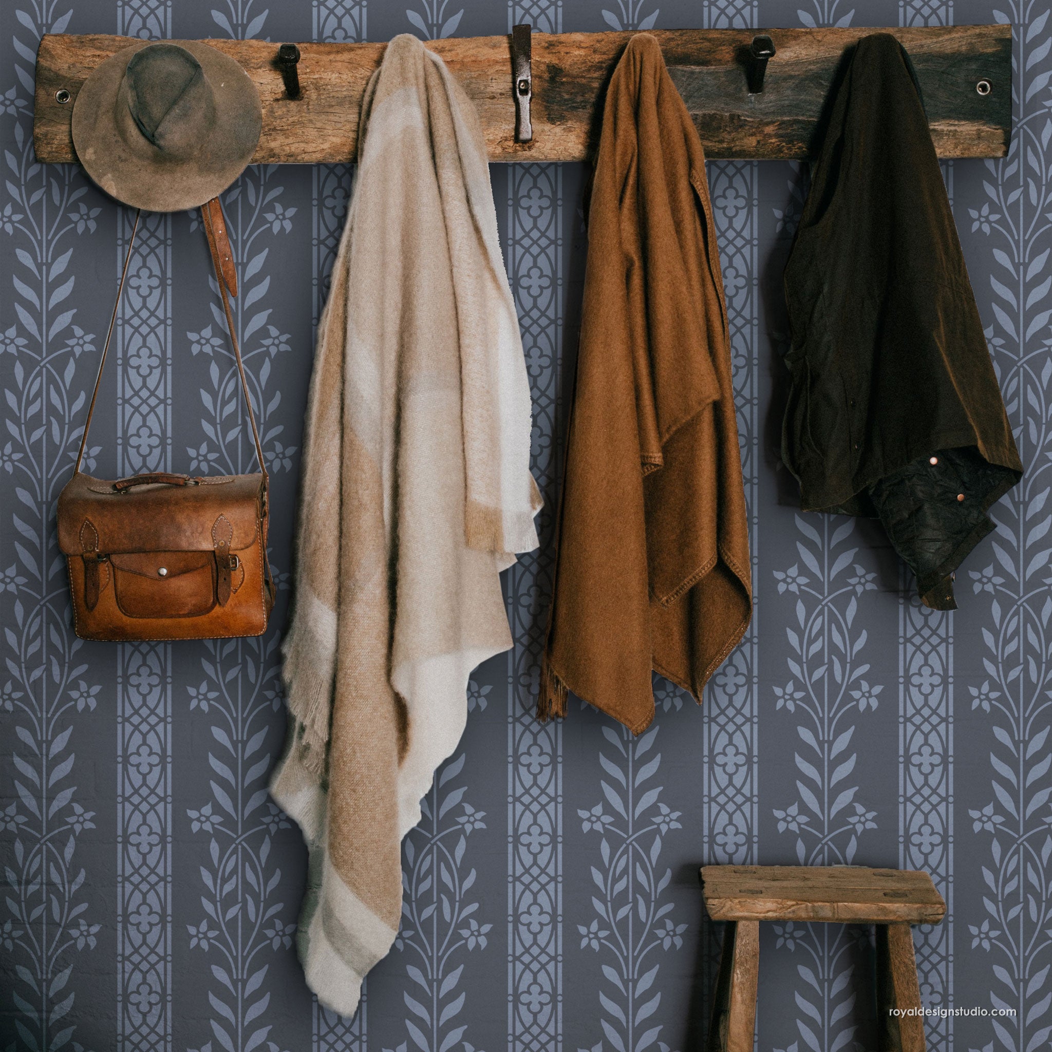 Wooden coat rack with various items including a hat, bags, and cloaks against a patterned wall.