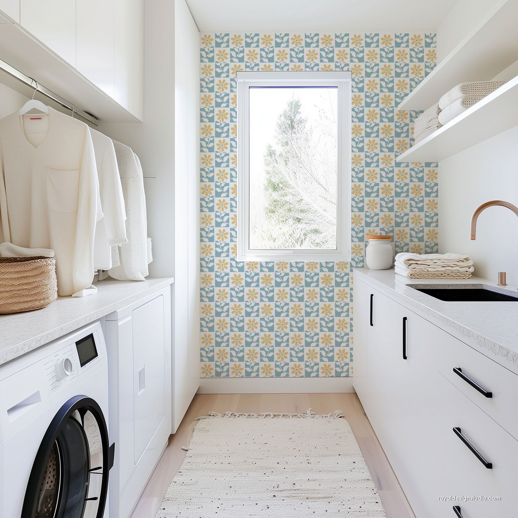 Modern laundry room with white cabinets, washing machine, and floral stencil wallpaper